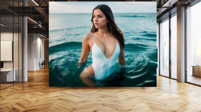 A curvaceous girl with dark long hair in a white one-piece swimsuit is half submerged in sea water against the background of a blue sky and sea horizon on a bright sunny day. Generative AI. Wall mural