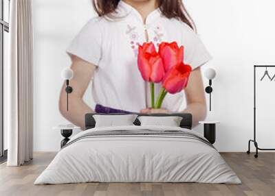 Smiling girl holding a bouquet of tulips Wall mural