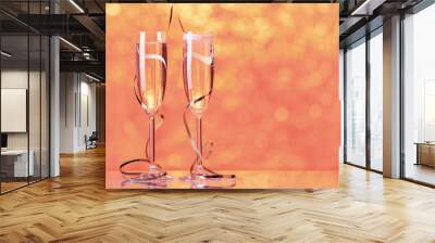 two full champagne glasses with bokeh lights in the background Wall mural