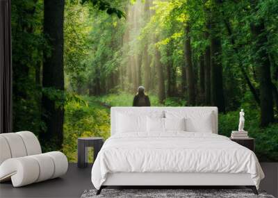 spring forest. woman in a picturesque forest. beautiful sun rays Wall mural