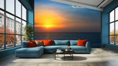 Beautiful red sunset over dark sea. Summer background. Wall mural