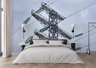 High voltage electricity transmission pole. Tower sky background. Wall mural