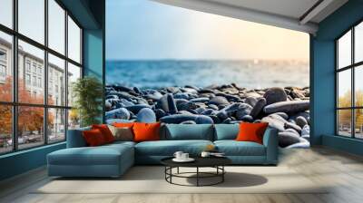 Sea stones and waves on the beach. Summer background. Wall mural