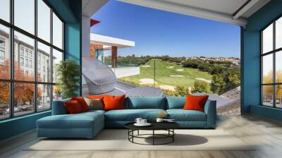 Beautiful view of Green Golf course landscape from luxury Balcony , with decorative chairs and table. Wall mural