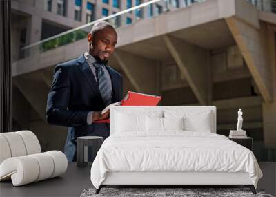 black businessman looking at his tablet computer in urban backgr Wall mural