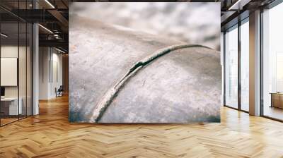 A fragment of the main pipeline for pumping gas. In the frame, the weld defect is a hole and a crack on the steel pipe. Color photo, shade of blue. Wall mural