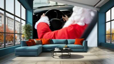 Authentic Santa Claus driving his modern car, outdoors Wall mural