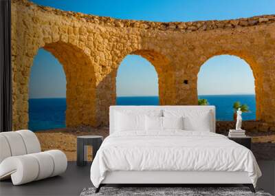 beautiful summer view of the blue sea and palm trees through the arch
 Wall mural