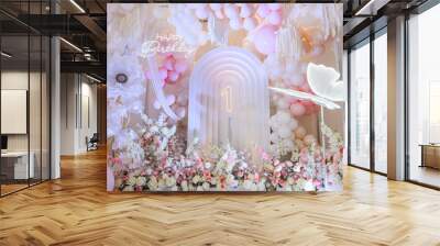 Birthday party for 1 year old girl on a background photo wall. Arch decoration pink, white balloons, text Happy Birthday, flowers, paper decor butterfly. Children's photo zone. Closeup. Wall mural