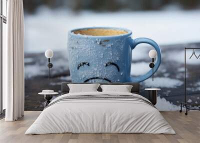 Blue Monday concept. Blue mug with a sad face, snowflakes on it.  Wall mural