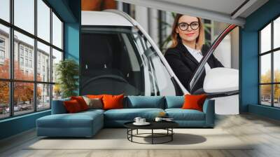 business woman in auto salon. concept of female driver Wall mural