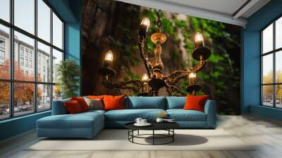 Chandelier with LED lamps in a modern house in nature style. Vintage pendants. Decorating a wedding dinner with antique chandeliers. Hanging lamp in luxury retro style on dark background Closeup. Wall mural