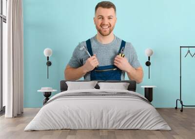 Close-up portrait of his he nice attractive cheerful cheery content guy repairer craftsman isolated over blue color background. Wall mural