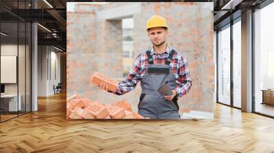 construction mason worker bricklayer installing red brick with trowel putty knife outdoors. Wall mural