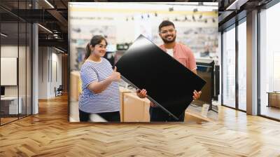 Couple in shopping. They are looking for a new tv Wall mural