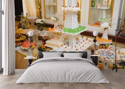 Delicious sweets on wedding candy buffet with desserts, cupcakes,tiramisu and cookies Wall mural