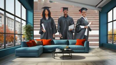 education, graduation and people concept - group of happy international students in mortar boards and bachelor gowns with diplomas Wall mural