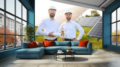 engineer and businessman planing new ecology project. around solar panel. Wall mural