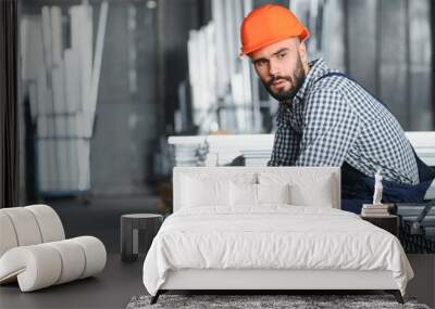 Factory worker measures the metal profile Wall mural