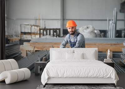 Factory worker measures the metal profile Wall mural