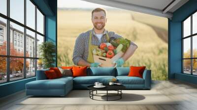 farmer carrying box of picked vegetables Wall mural