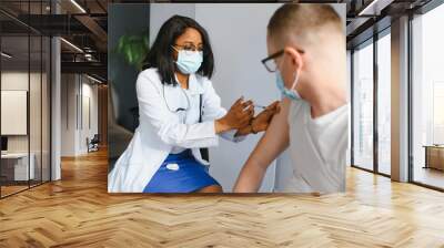 female african doctor injecting a patient Wall mural