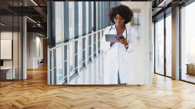 happy african doctor using tablet computer Wall mural