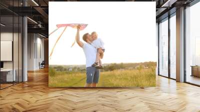 Happy father's day. Child girl and dad with a kite on nature in summer Wall mural