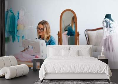 happy young fashion deisgner in her studio. concept of tailoring Wall mural