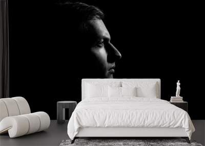 Dramatic portrait of a guy on a black background, black and white photography Wall mural