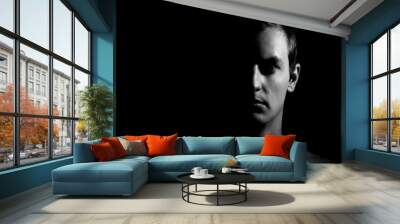 Dramatic portrait of a guy on a black background, black and white photography Wall mural