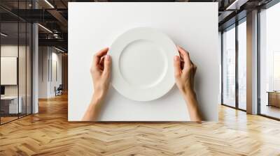 Holding Plate. Female Hands Present Empty White Plate Concept on Table Wall mural