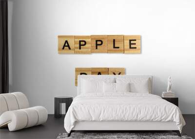 Top view of the word apple day laid out from square wooden tiles isolated on white background. World and international day. Wall mural