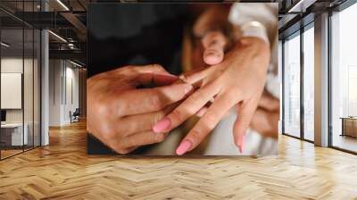 Man in love putting an engagement ring on woman finger. Propose. Closeup hands. Offer of hand and heart. Man holding his girl's hand - Man making a marriage proposal to his girlfriend. Engaged couple. Wall mural