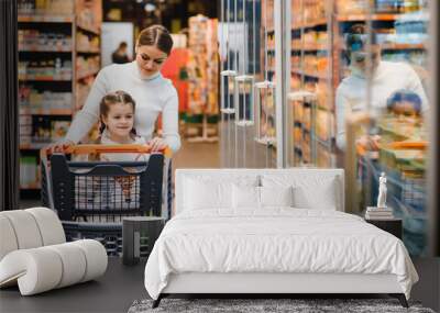 Mother with daughter at a grocery store Wall mural