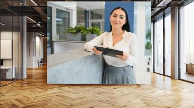 Picture of pretty receptionist at work. Wall mural