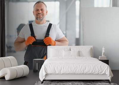 Portrait of a builder in the process of working on a construction site indoors Wall mural