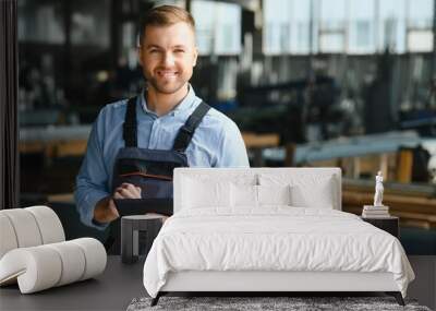 Portrait of factory worker. Young handsome factory worker. Wall mural