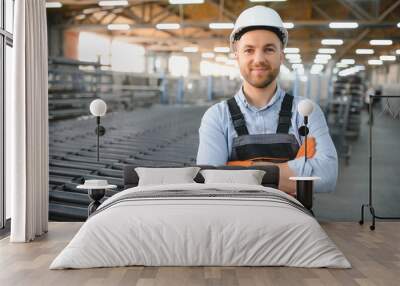 Portrait of factory worker. Young handsome factory worker. Wall mural