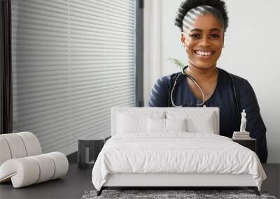 Portrait Of Smiling Female Doctor Wearing White Coat With Stethoscope In Hospital Office Wall mural