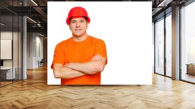 Portrait smiling handsome worker with folded arms, wearing construction helmet and orange informal t-shirt Wall mural