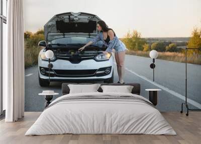 Sad woman depressed not knowing what to do with broken car Wall mural