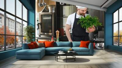 Smiling chef in his kitchen Wall mural