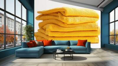 Stack of yellow towels on a white background, isolated Wall mural