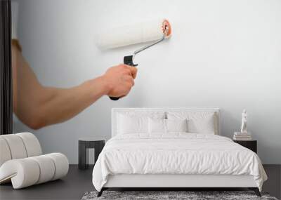 The painter is painting a wall in a room with a roller. Wall mural