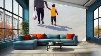 Two pedestrians cross the road jaywalk in the middle of the street. Wall mural