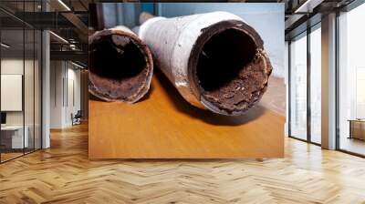 Two pieces of an old sewer pipe. Apartment in a multi-storey residential building in the city. Heavy pollution. Horizontal frame. Soft focus Wall mural