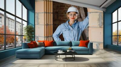 Warehouse woman worker. Woman builder in hardhat. Girl engineer or architect. Home renovation. Quality inspector. Construction job occupation. Construction worker. Lady at construction site. Wall mural