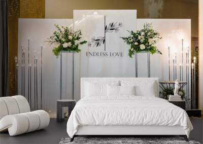 Wedding reception for luxury ceremony. Copy space. Celebration concept. Photo-wall, arch place decorated candles and flowers, greenery. Trendy decor for wedding party in the banquet area. Wall mural