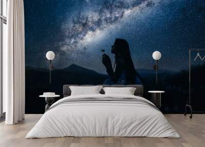 Woman looking at beautiful milky way. Beautiful woman in a long white dress in the mountains. Girl sitting on a rock. Milky Way at mountains. Night colorful landscape. Starry sky with hills at summer Wall mural